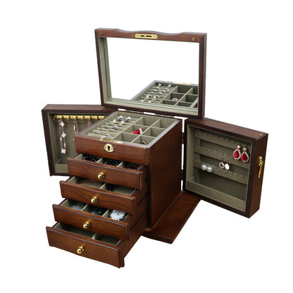 Wooden jewelry box by edenista in warm brown wood with brass hardware, mirrored lid, and multiple drawers