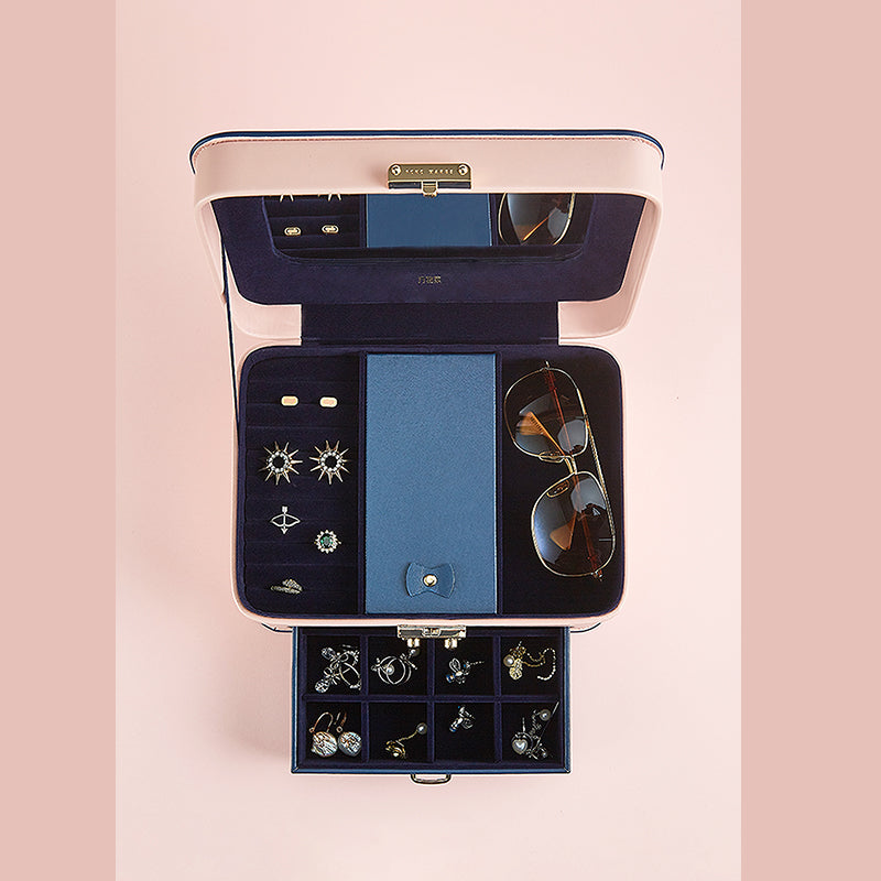 edenista pink jewelry storage box with blue lining, open to reveal top tray, sunglasses, rings, and a small drawer