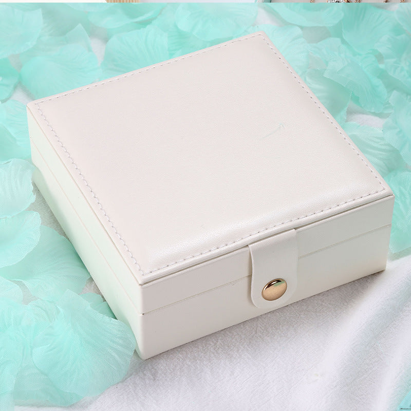 Jewelry storage box by edenista, square white PU leather with snap strap.