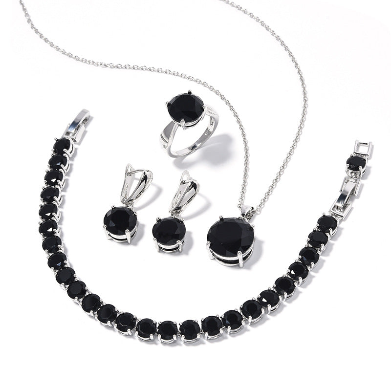 Geometric round jewelry set by cj: black stones on silver-tone metal with bracelet, necklace, ring and earrings