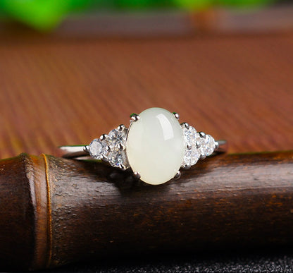 Adjustable moonstone jade ring with 925 silver setting and clear side stones