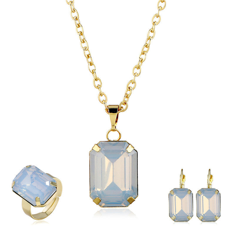 Bridal jewelry set: gold-tone necklace with a blue rectangular pendant, plus matching ring and earrings (3-piece).