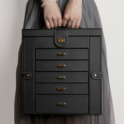 Multifunctional jewelry box by edenista in black leather with gold hardware and stacked drawers.
