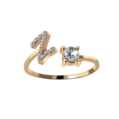 Gold adjustable ring with a diamond-studded end and a solitaire diamond setting