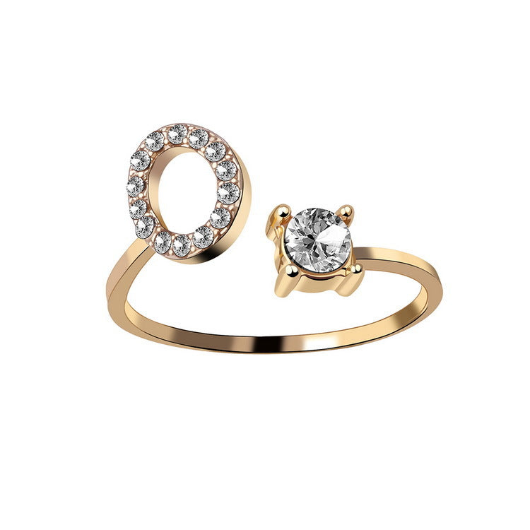 Gold-tone adjustable ring with pave diamond halo circle and a solitaire diamond end