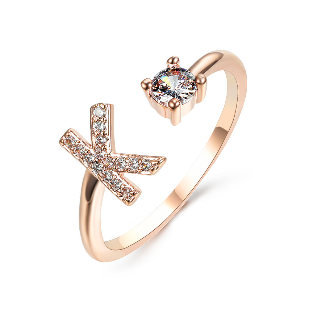 Rose gold adjustable ring with X-shaped pavé accents and a solitaire center stone, edenista