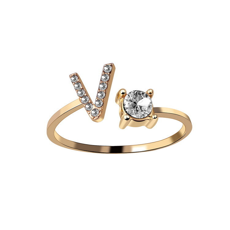 Gold adjustable initial letter V ring with pave crystals and a solitaire stone