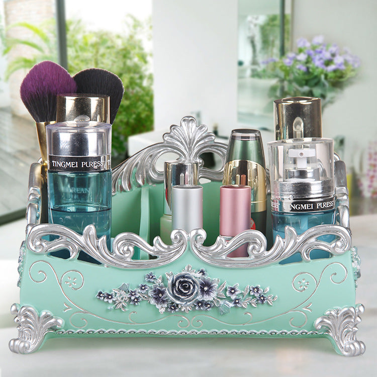 Desktop jewelry box in mint with ornate silver filigree, showcasing makeup bottles and brushes