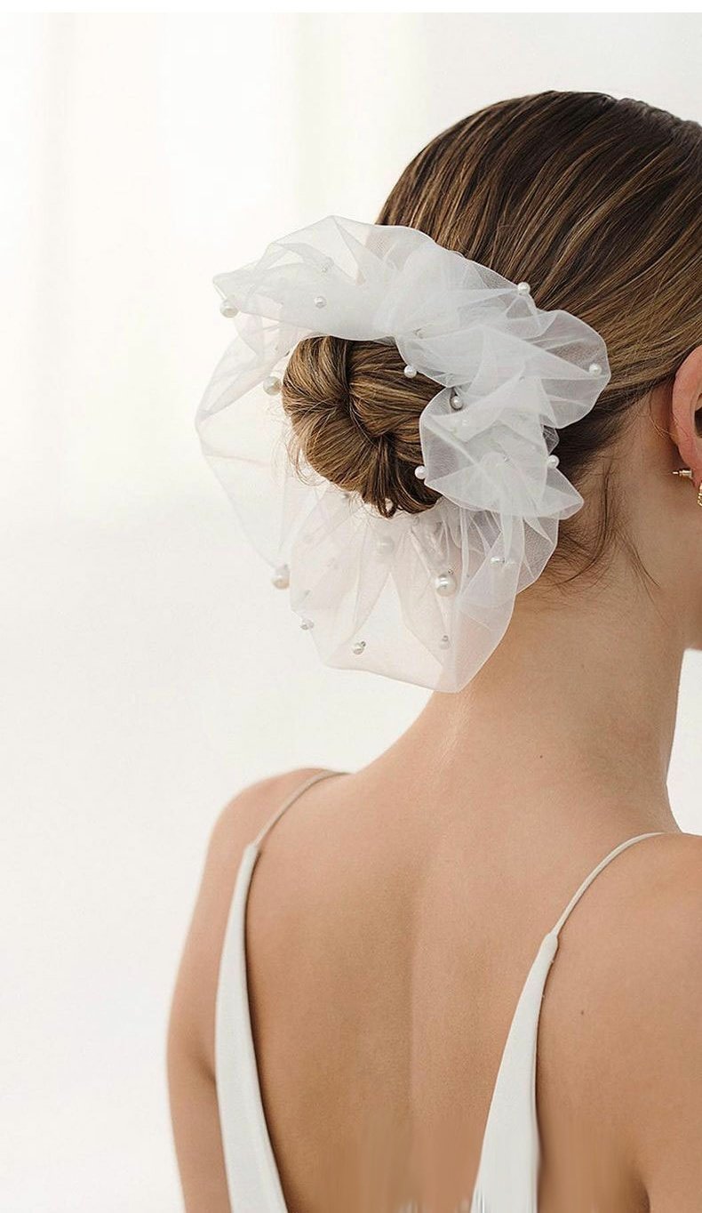 Bridal veil hair accessory in pearl-white mesh with scattered pearl accents