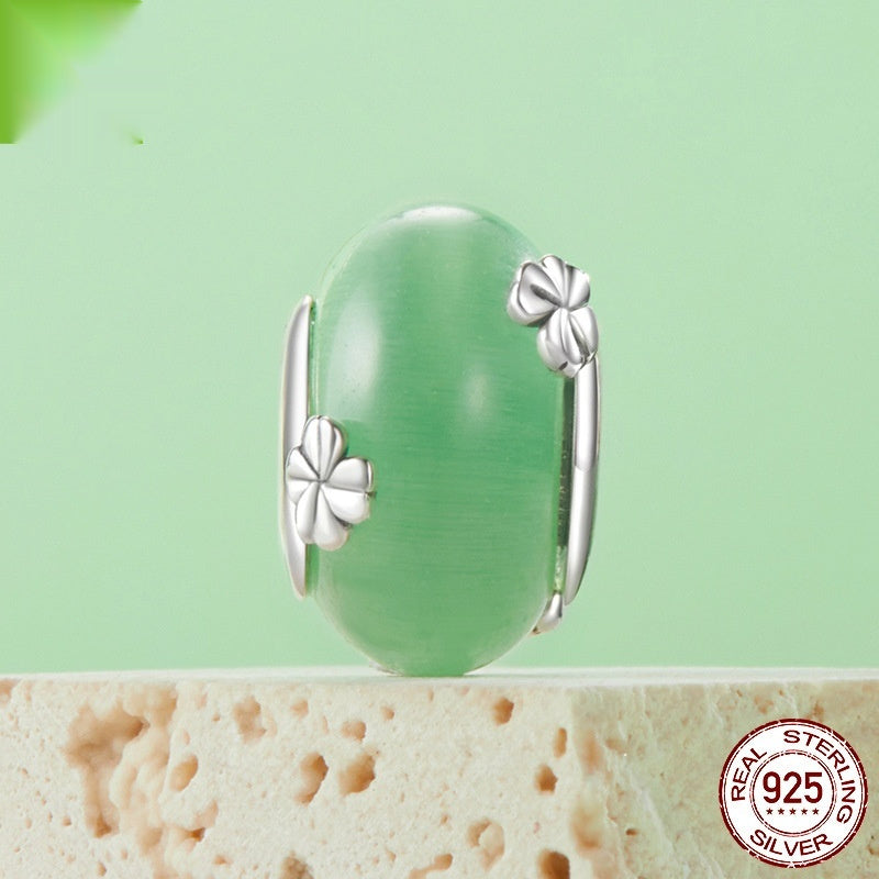 Bead bracelet with a green bead and silver floral accents, 925 sterling silver