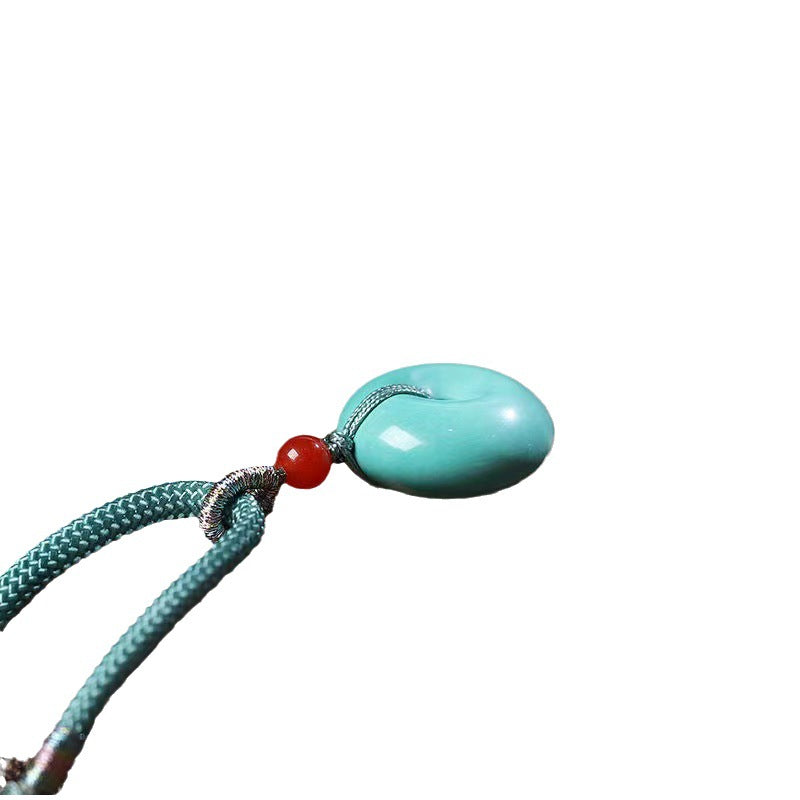 High Porcelain Turquoise Bread Ring Safety Buckle pendant on teal cord with red bead and metal loop