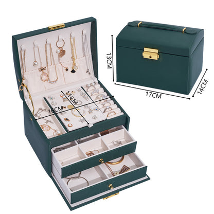 Three-layer green drawer jewelry storage box with gold hardware and organized compartments
