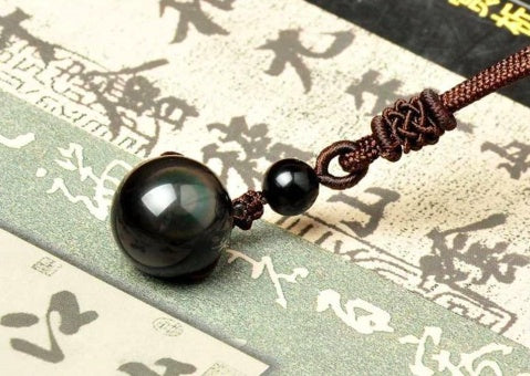 Natural obsidian rainbow-eye pendant necklace on brown rope cord; large black orb with small bead