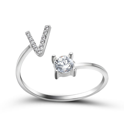 Adjustable silver-tone ring with a V-shaped crystal row and a solitaire round stone.