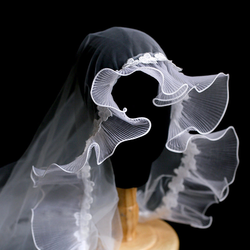 Vintage fairytale bridal lace veil by CJ in white with a ruffled scalloped edge.