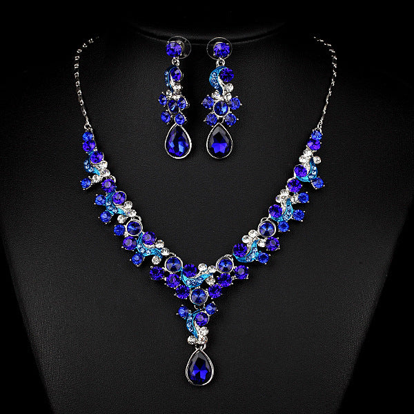 Necklace and earrings two-piece set with blue crystals, clear stones, and teardrop pendant