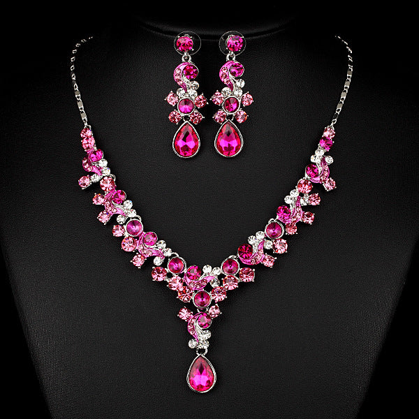 Two-piece jewelry set: pink crystal necklace with drop pendant and matching earrings, cj brand.