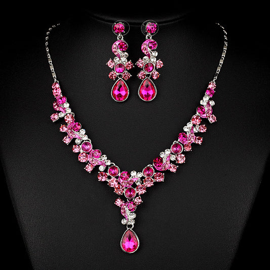 Two-piece jewelry set: pink crystal necklace with drop pendant and matching earrings, cj brand.