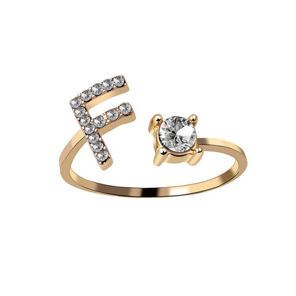 edenista adjustable gold-tone initial F ring with pave diamonds and a solitaire diamond