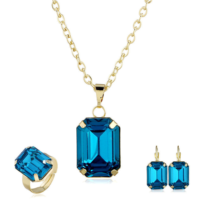 3-piece bridal jewelry set CJ: blue emerald-cut pendant necklace with matching ring and earrings in gold-tone
