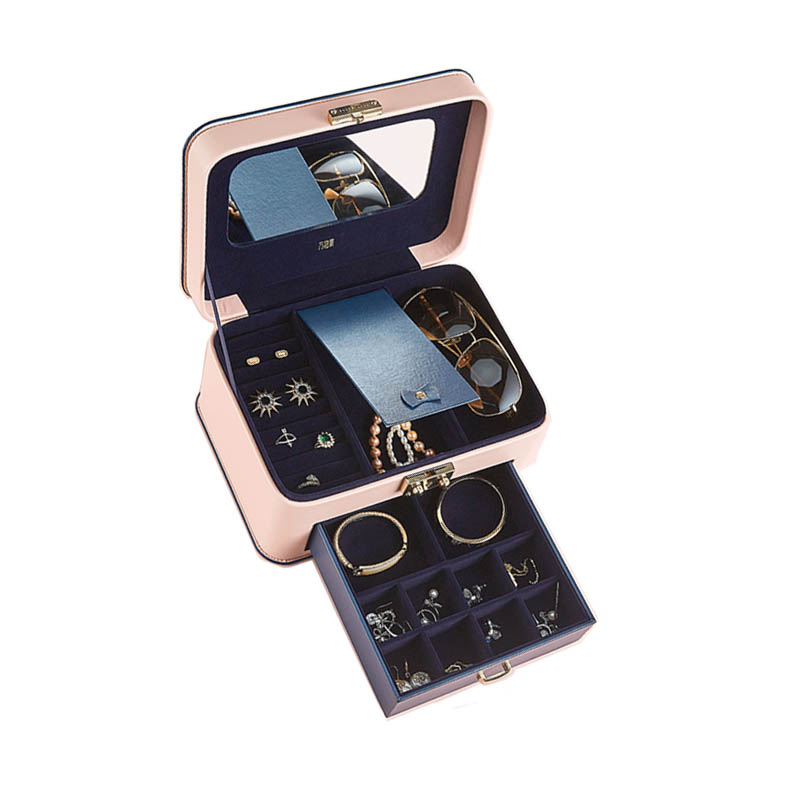 Jewelry storage box in pink with navy lining, multiple compartments and a pull-out drawer.
