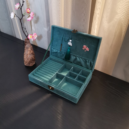 Jewelry box Edenista, teal velvet, open with padded compartments and tassel accents.