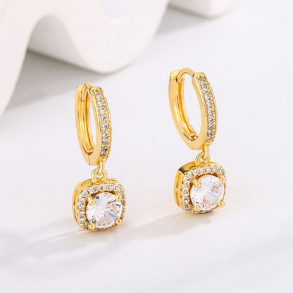 Pair of gold-tone hoop earrings with pave crystals and a dangling clear round stone halo