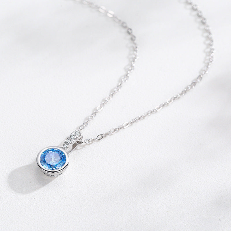Women's sea blue artificial diamond pendant necklace with a round blue gemstone in a bezel setting on a silver-tone chain by CJ
