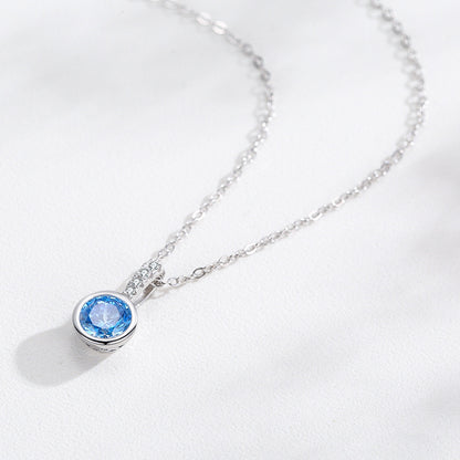 Women's sea blue artificial diamond pendant necklace with a round blue gemstone in a bezel setting on a silver-tone chain by CJ