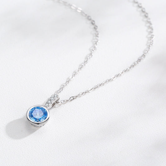 Women's sea blue artificial diamond pendant necklace with a round blue gemstone in a bezel setting on a silver-tone chain by CJ
