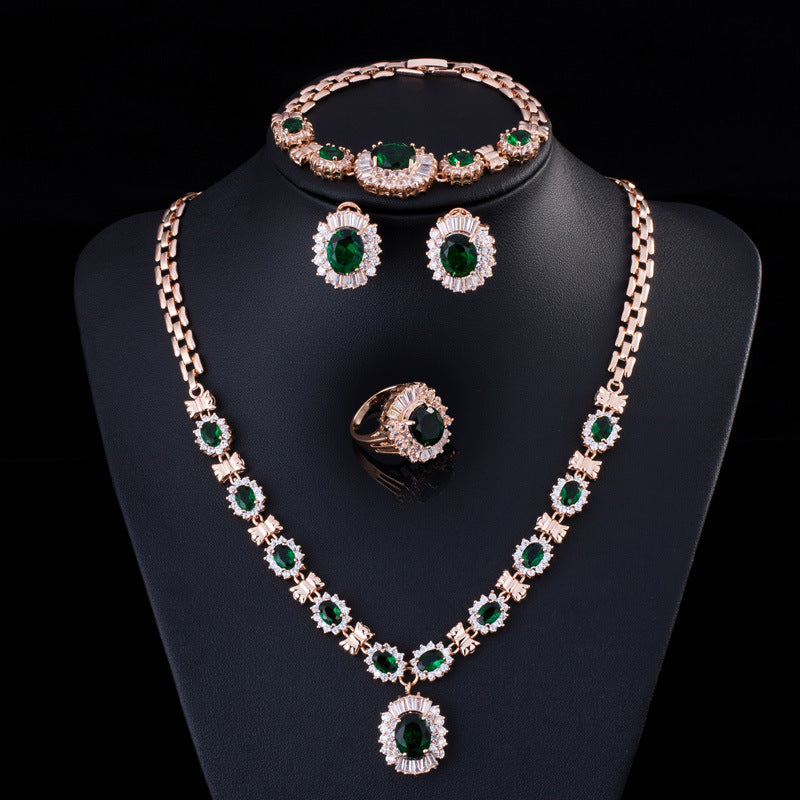 Zircon necklace set with bracelet, earrings, and ring in rose-gold tone and emerald-green stones