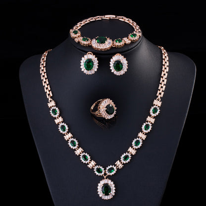 Zircon necklace set with bracelet, earrings, and ring in rose-gold tone and emerald-green stones