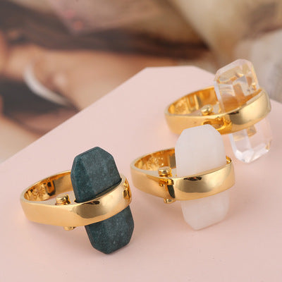 Rectangular natural stone rings with gold bands in teal, white, and clear; set of three.