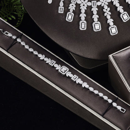 Zircon four-piece jewelry set: necklace, bracelet, ring and earrings in silver-tone with sparkling stones