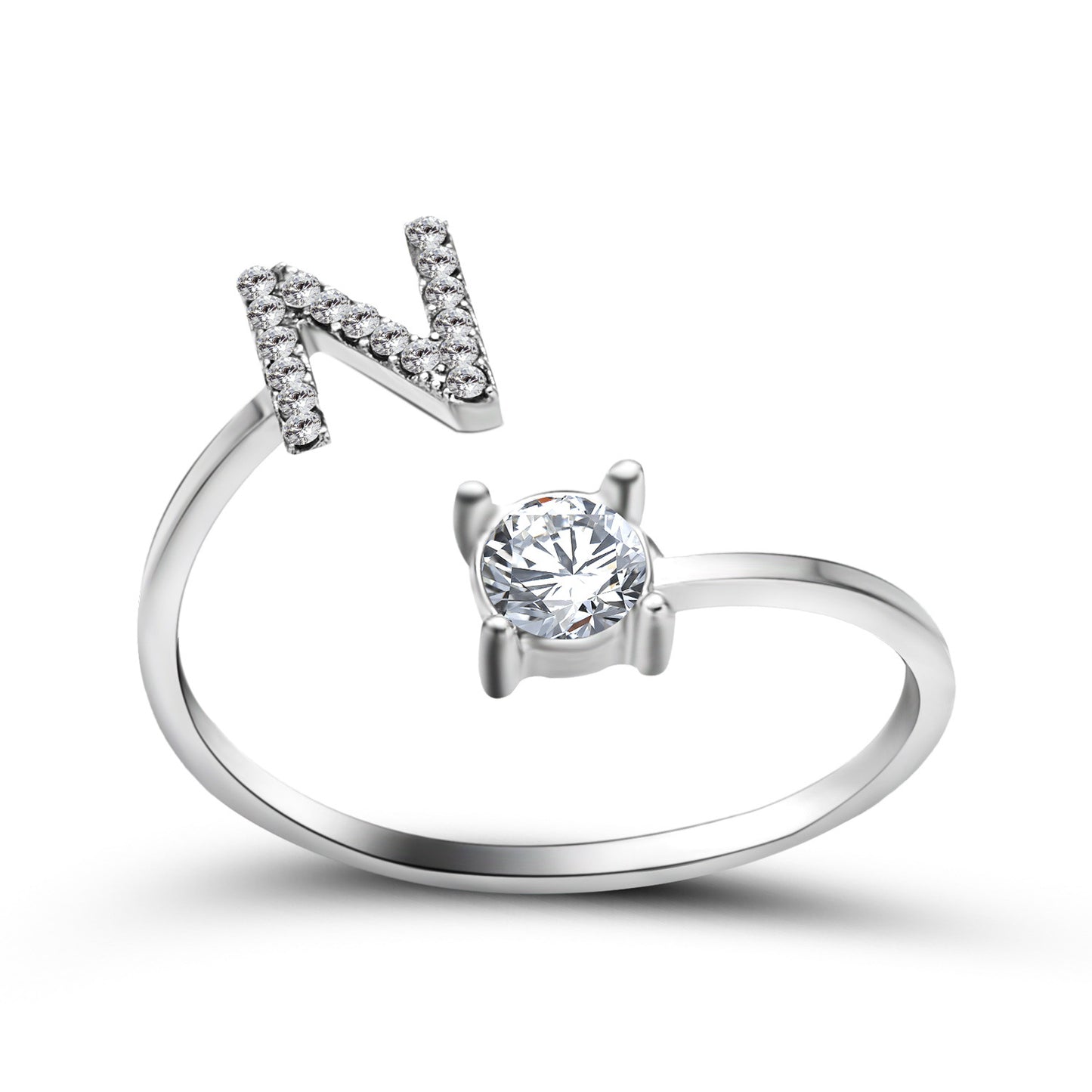 Ring by edenista with N initial pavé diamonds and a solitaire diamond on a silver-tone band, adjustable