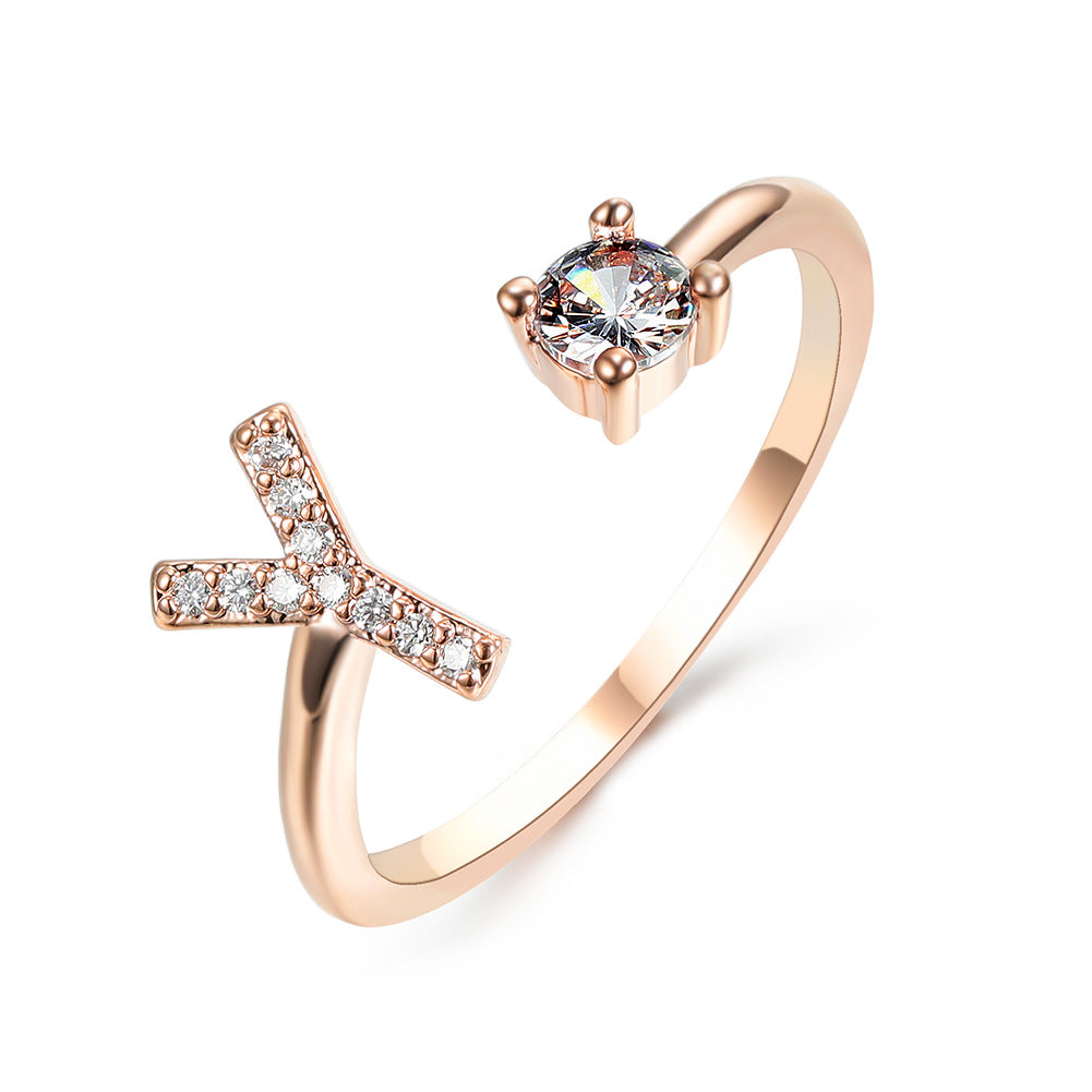 Rose gold adjustable initial-letter ring with X-shaped pave diamonds and a solitaire diamond end