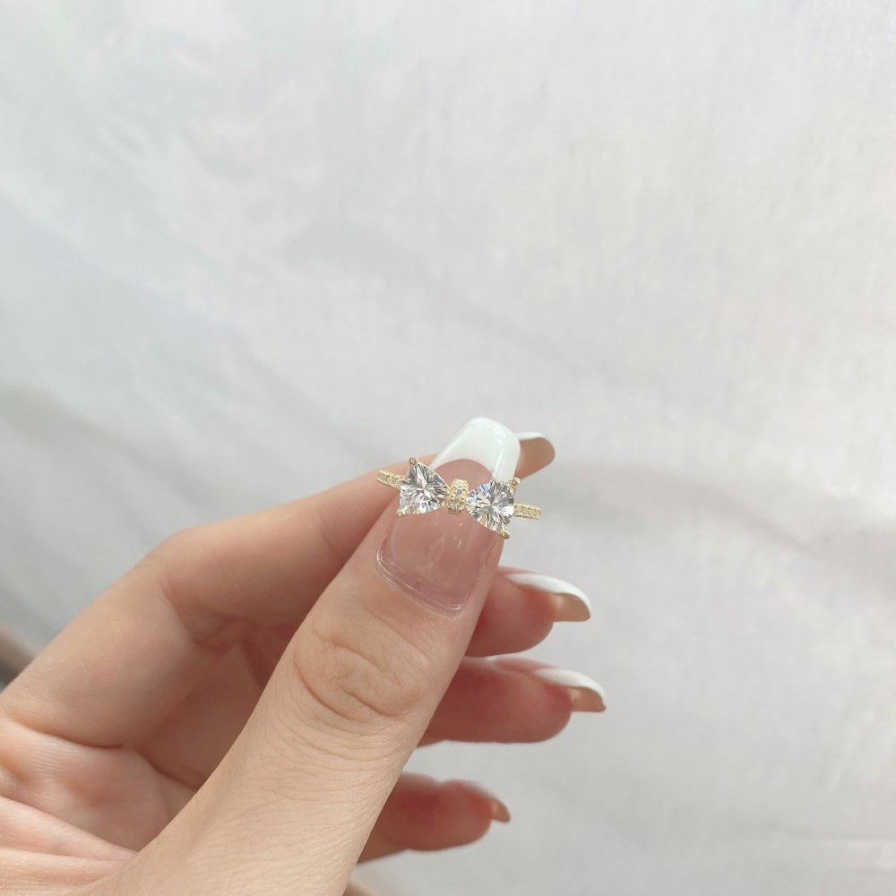 S925 sterling silver bow ring with two clear stones on a slim band