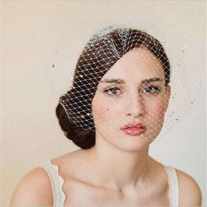 White bridal veil with rhinestone mesh attached to a hand-sewn hair comb