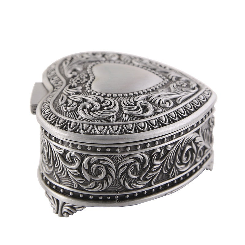 Jewelry storage box by Edenista, heart-shaped silver with ornate scrollwork and beaded edge.