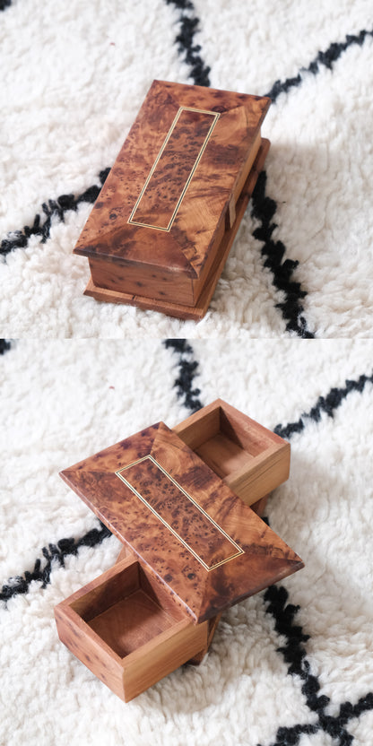 Moroccan handmade rotating wooden jewelry box with burl wood finish and a gold-inlaid rectangular lid.