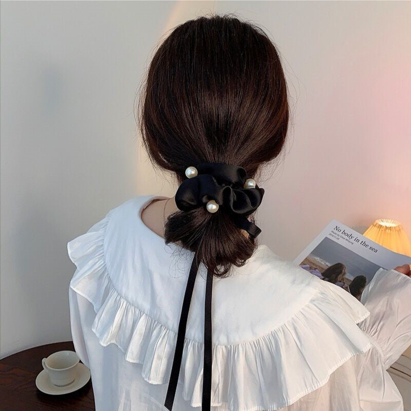 Women's pearl ribbon hairband with bow knot, black satin ribbon and white pearls.
