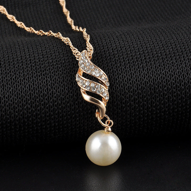 Pearl pendant necklace with gold-tone spiral pave crystals and a white drop pearl, cj bridal jewelry.