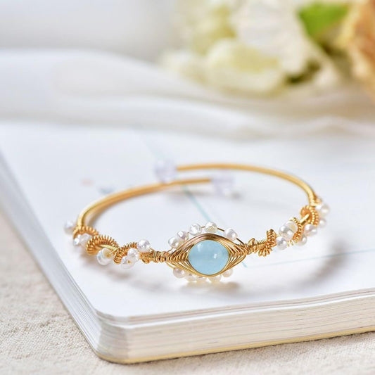 Pearl bracelet, gold-plated wire-braided vintage cuff with blue centerpiece and pearl beads