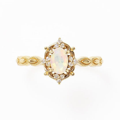 Gold-tone opal ring with ornate vintage setting and small accent stones