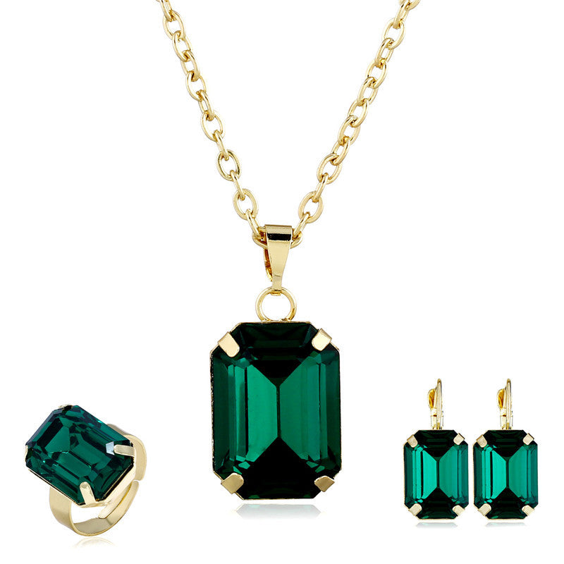 Bridal jewelry set CJ with emerald-green stones in gold-tone; necklace, ring, and earrings (3-piece)