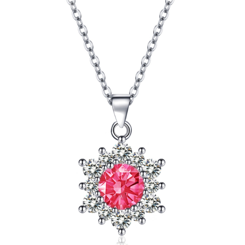 Snowflake pendant necklace with pink center stone surrounded by clear stones on a silver chain