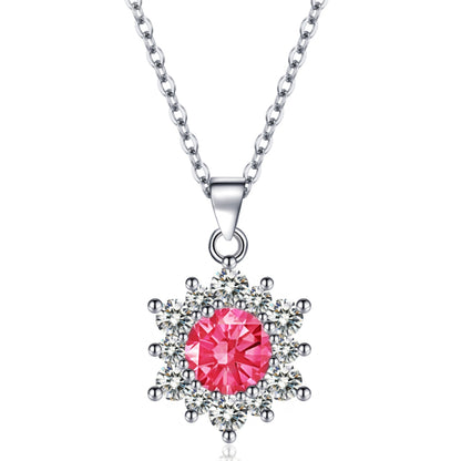 Snowflake pendant necklace with pink center stone surrounded by clear stones on a silver chain