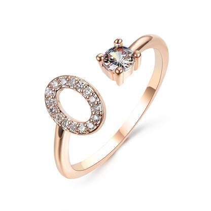 Rose gold adjustable open-ended ring with a crystal halo on one end and a solitaire stone on the other.
