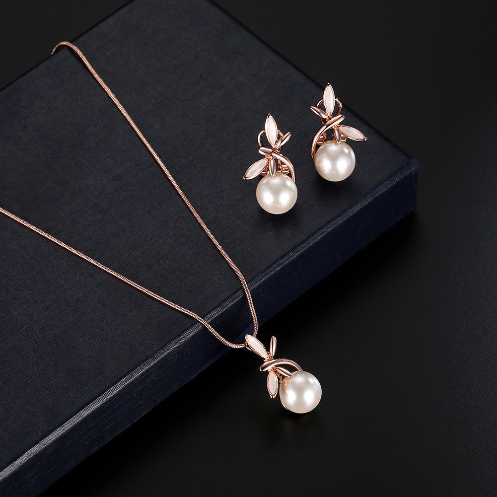 Pearl necklace and earrings set in rose-gold tone with leaf accents; two-piece bridal party jewelry for an elegant look