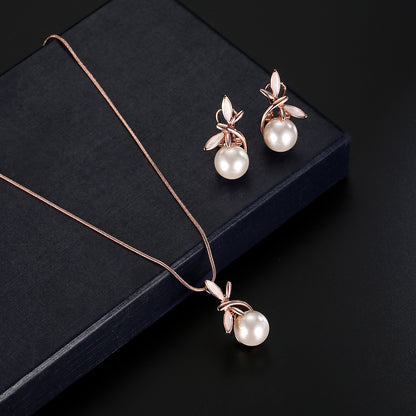 Pearl necklace and earrings set in rose-gold tone with leaf accents; two-piece bridal party jewelry for an elegant look